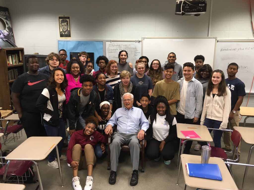 Group photo of students on field trip with holocaust survivor