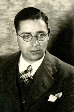 Rude Kemp photo looking down wearing glasses and collared jacket